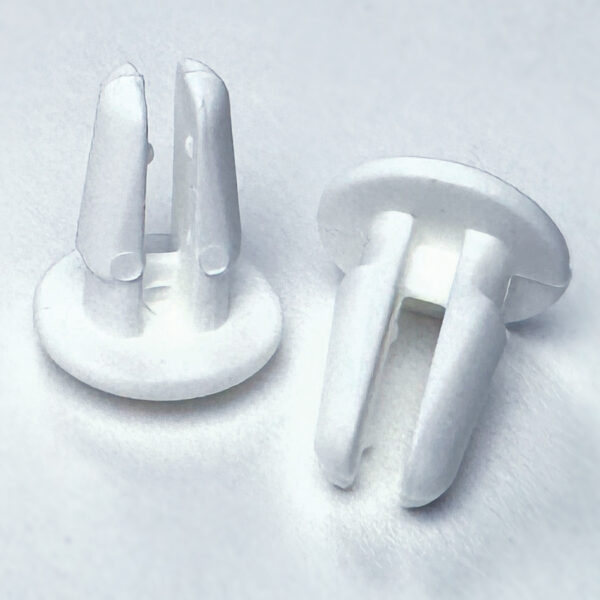 Small, white plastic, shelf push-pins.