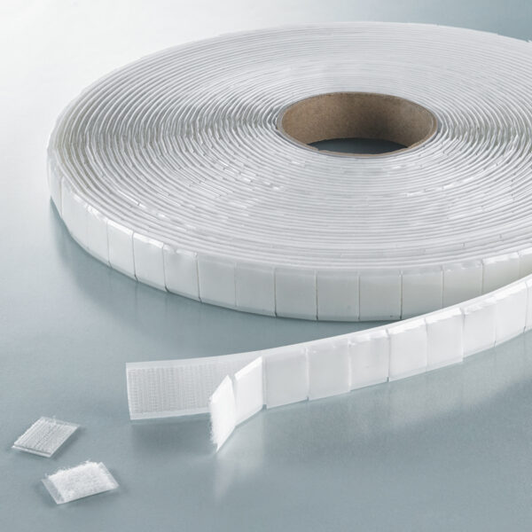 Velcro hook and loop pre-mated segments on rolls in white.