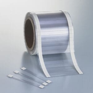 Flexible, plastic, sign wobblers with adhesive tabs on the roll.