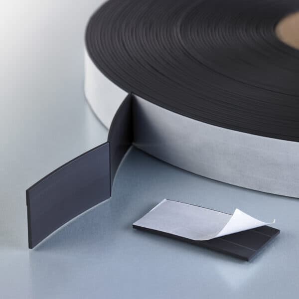 Adhesive-backed magnetic tape segments, kiss-cut on the roll.