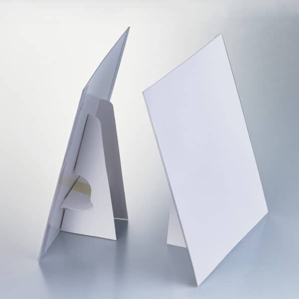White easels with clear, plastic, front sheet protectors.