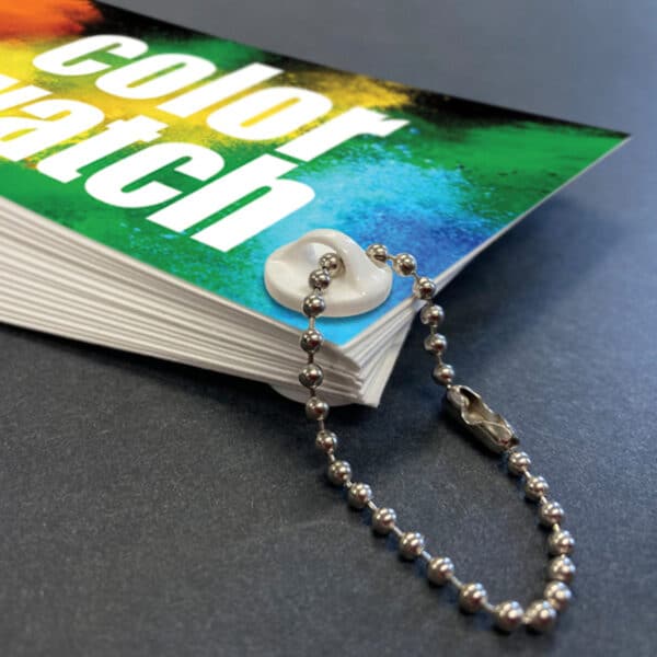 A color-sample book bound together with a Popco loop screw and strung with a loop of beaded chain.