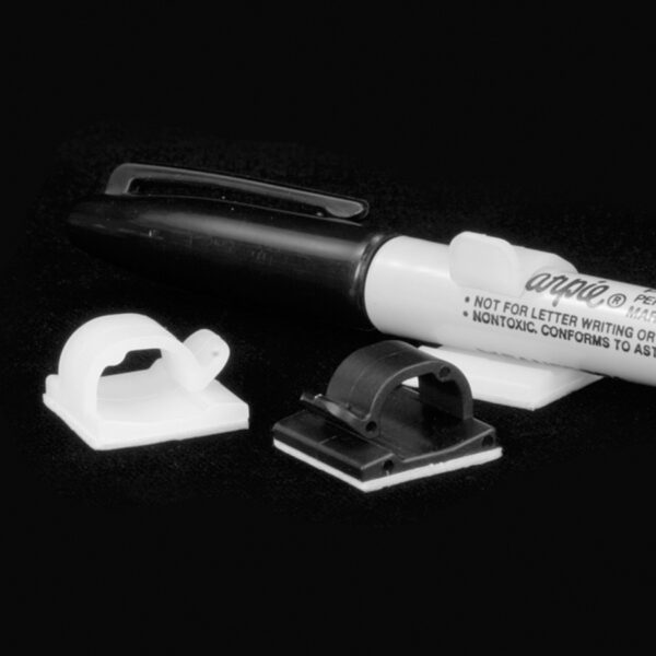 Pen clips in black and white, with adhesive backing, shown with a Sharpie Pen.
