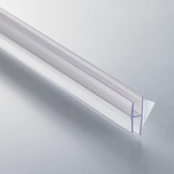 A thin, clear plastic, H-channel with a white foam adhesive strip on the back.