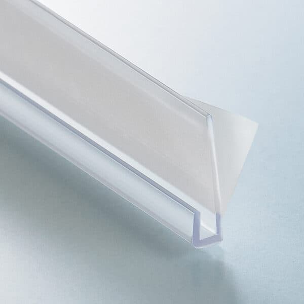 A thin, clear plastic, J-channel with a white foam adhesive strip on the back.