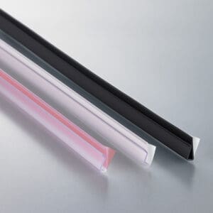 Three pinch-grip, plastic, sign channels in clear and black with either film or foam adhesive strips on the back.