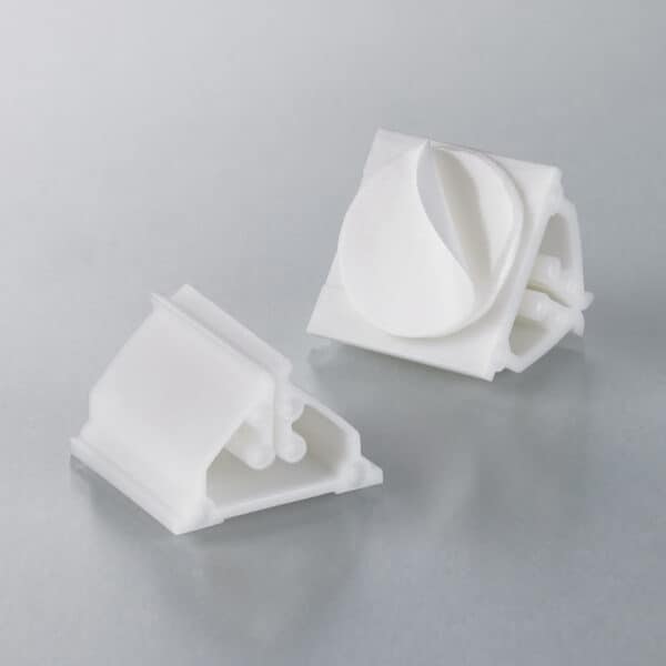 Two mini card-holders with adhesive tabs in white plastic.