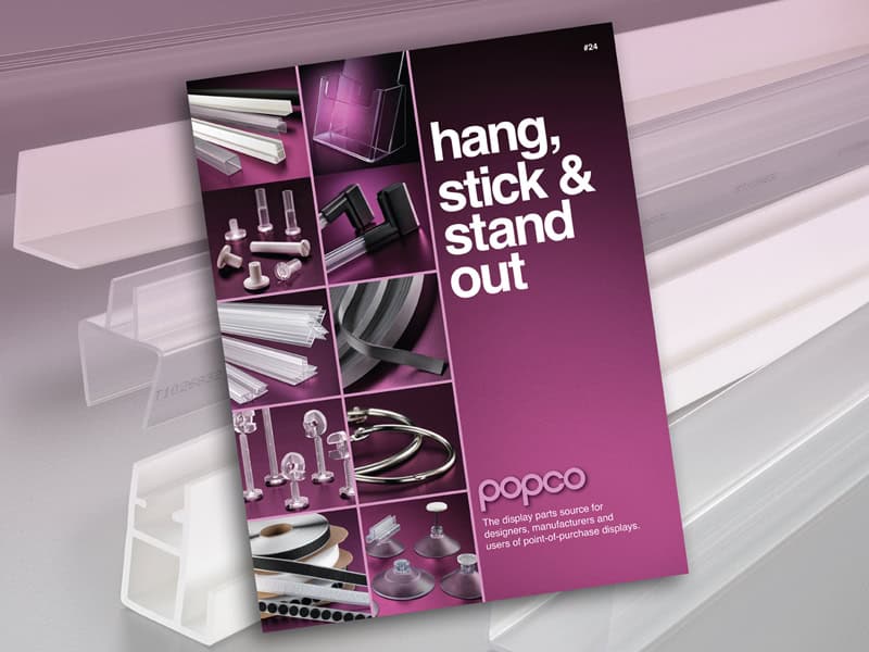 Popco's 2024 catalog cover shown with a collection of Popco extruded plastic rails for point-of-purchase.