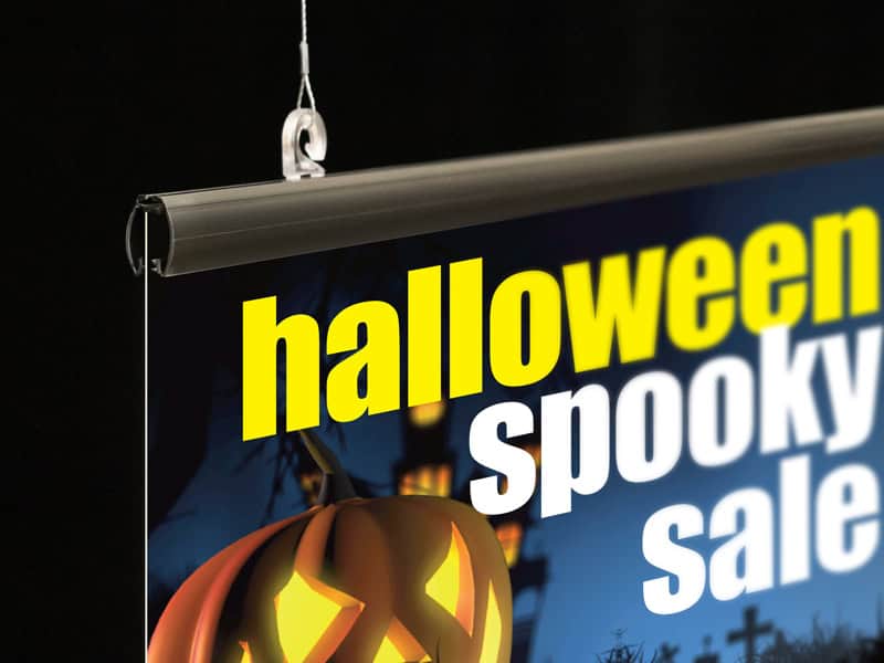 Popco's sign hanging rail and hanging hardware supports a halloween marketing poster.