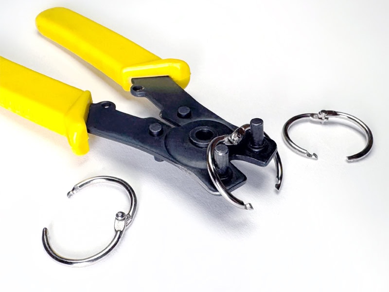 A seal-ring pliers with three steel book rings.