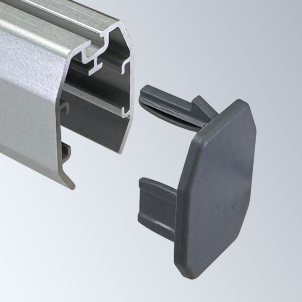 New aluminum snap rail end cap shown in position to insert into an aluminum snap rail shroud.