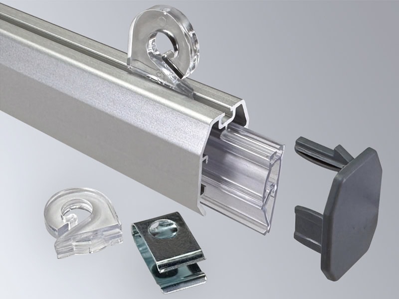 Popco’s aluminum Snaprail™ components and extras, featuring two clear banner clips (one installed on the aluminum shroud), one aluminum banner clip, one clear Snaprail™ (partially inserted into the aluminum shroud), one aluminum shroud and one grey end cap.