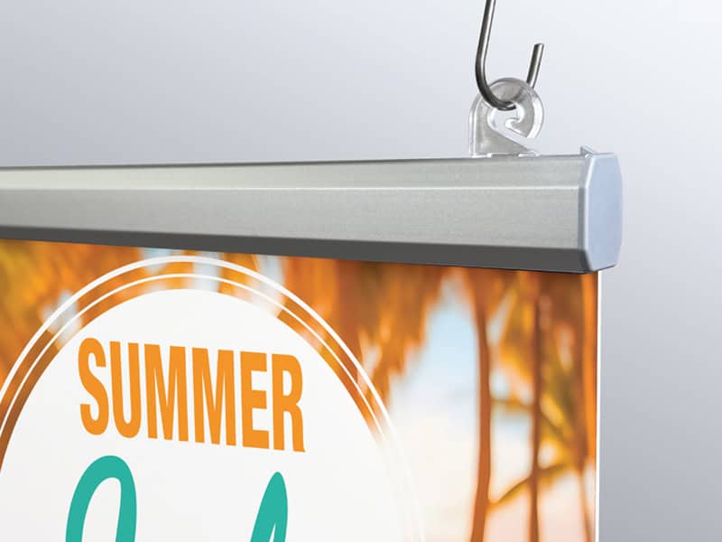 Popco’s aluminum Snaprail™ assembled, holding a sign, and shown hung using a plastic banner clip.