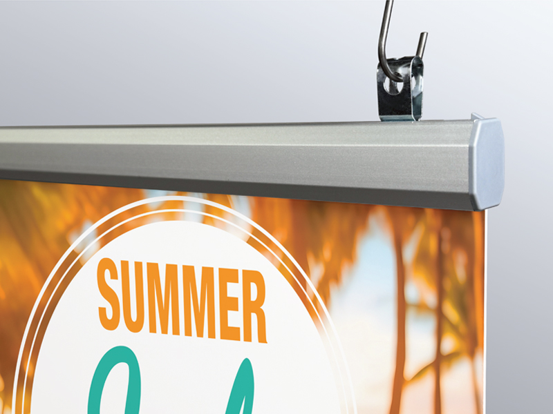 Popco’s aluminum Snaprail™ assembled, holding a sign, and shown hung using an aluminum banner clip.