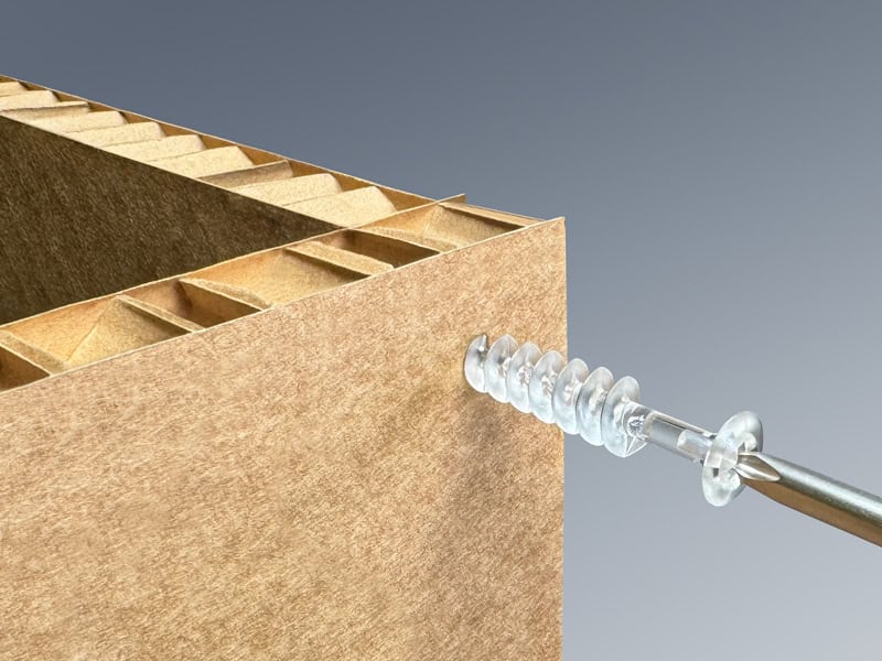 Popco honeycomb screw being installed in a piece of honeycomb fluted cardboard