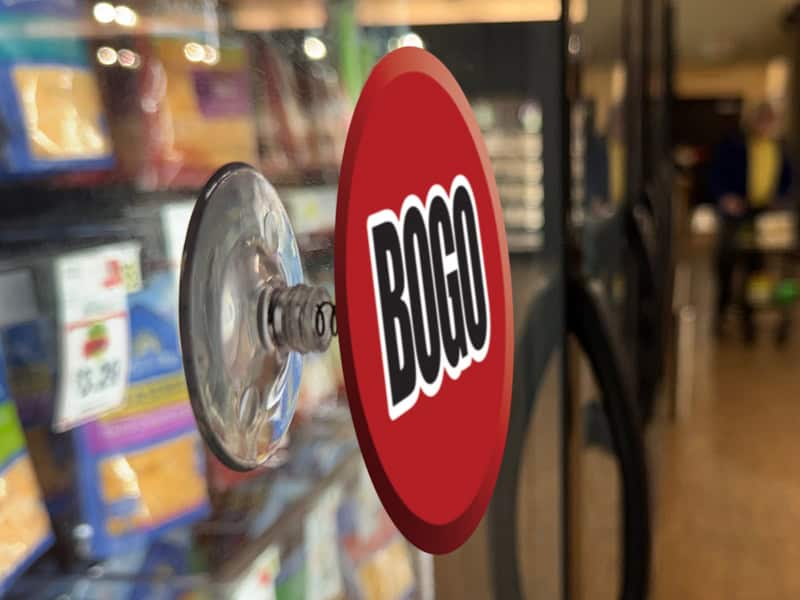 aug2026_blogImage_02 Popco suction cup with spring sign holder holding a sign on a grocery cooler