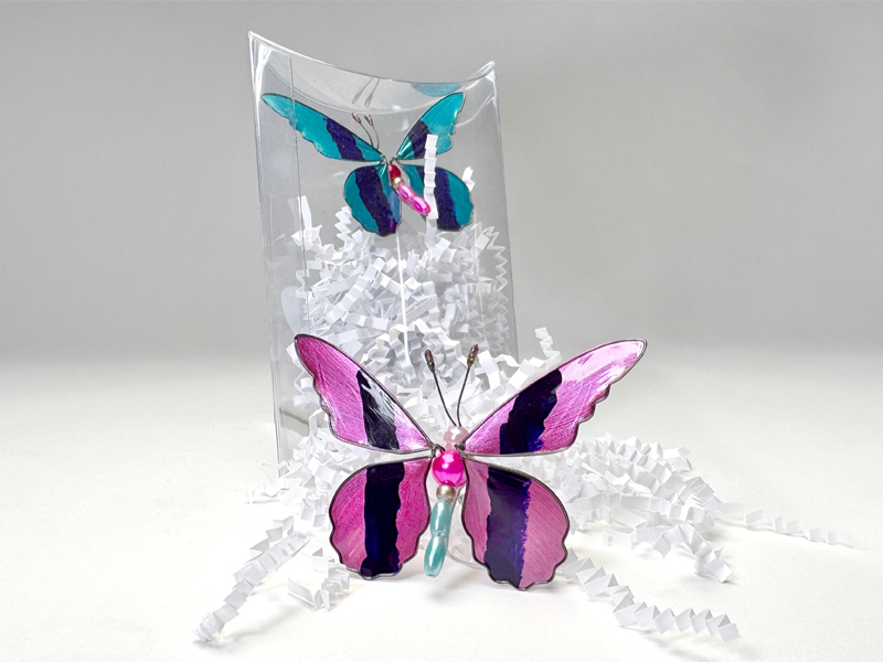 Bugz butterfly figurines shown in and out of the package.