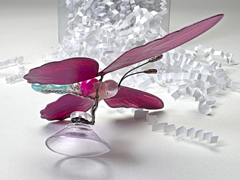 Bugz butterfly figurine shown attached to a Popco suction cup.